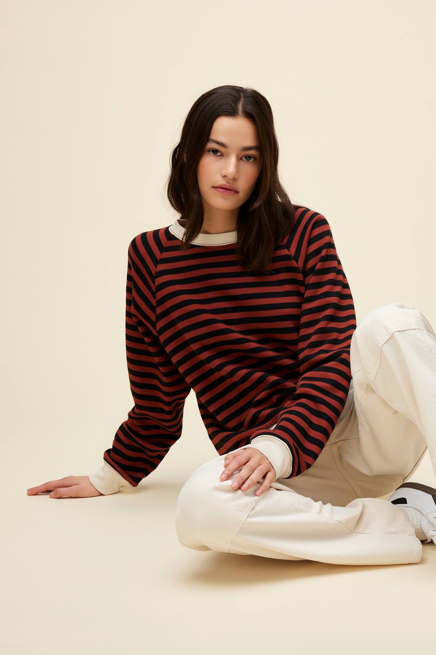 A model featuring a brown combo stripe vintage sweatshirt