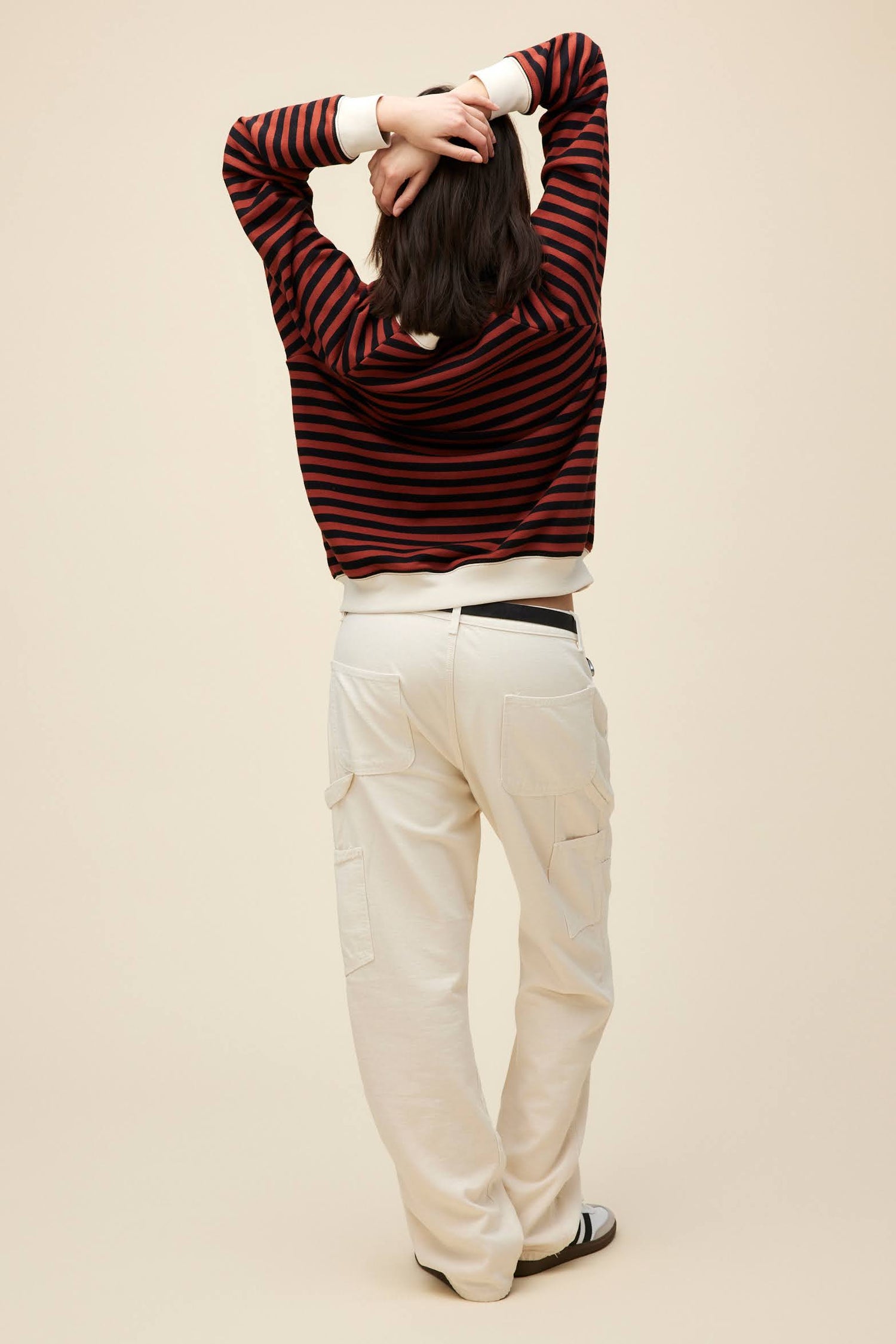 A model featuring a brown combo stripe vintage sweatshirt