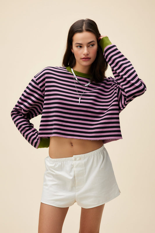 A model featuring a striped cut-off sweatshirt in lotus flower combo