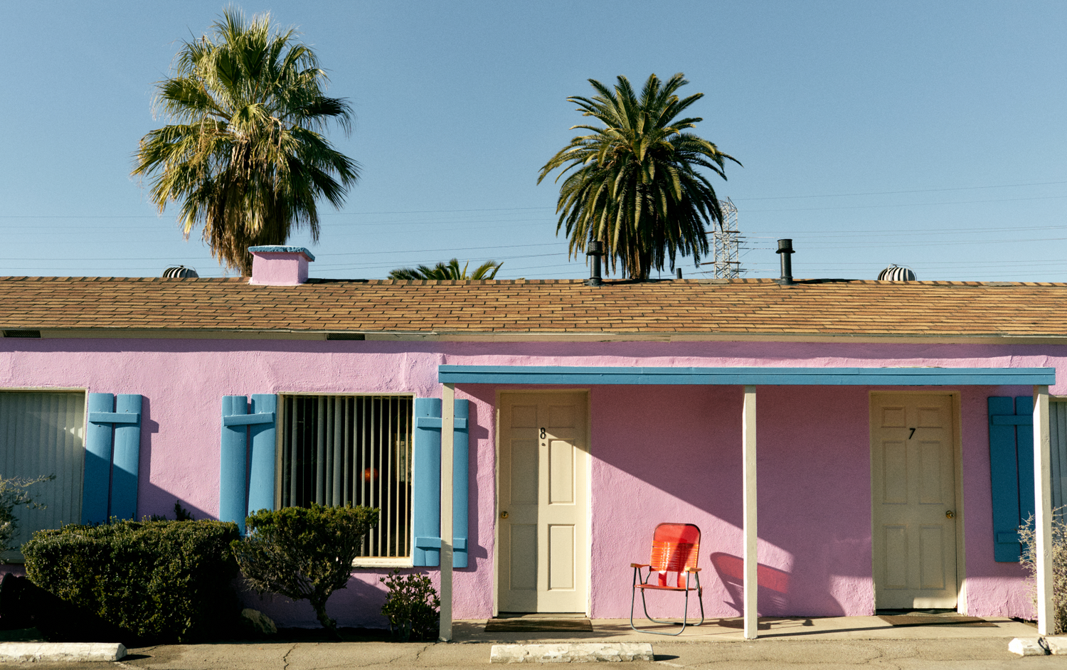 PINK MOTEL WITH ORANGE CHAIR
