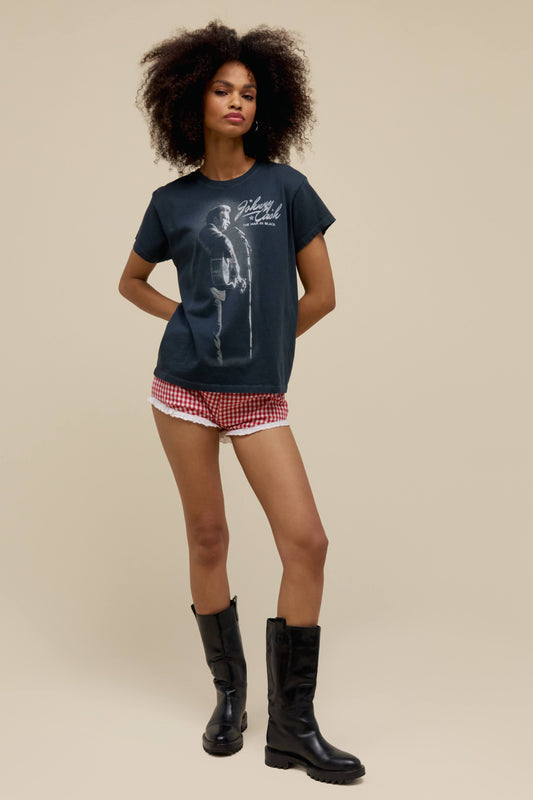 A  model featuring a black tour  tee stamped with 'Johnny Cash' and his portrait.
