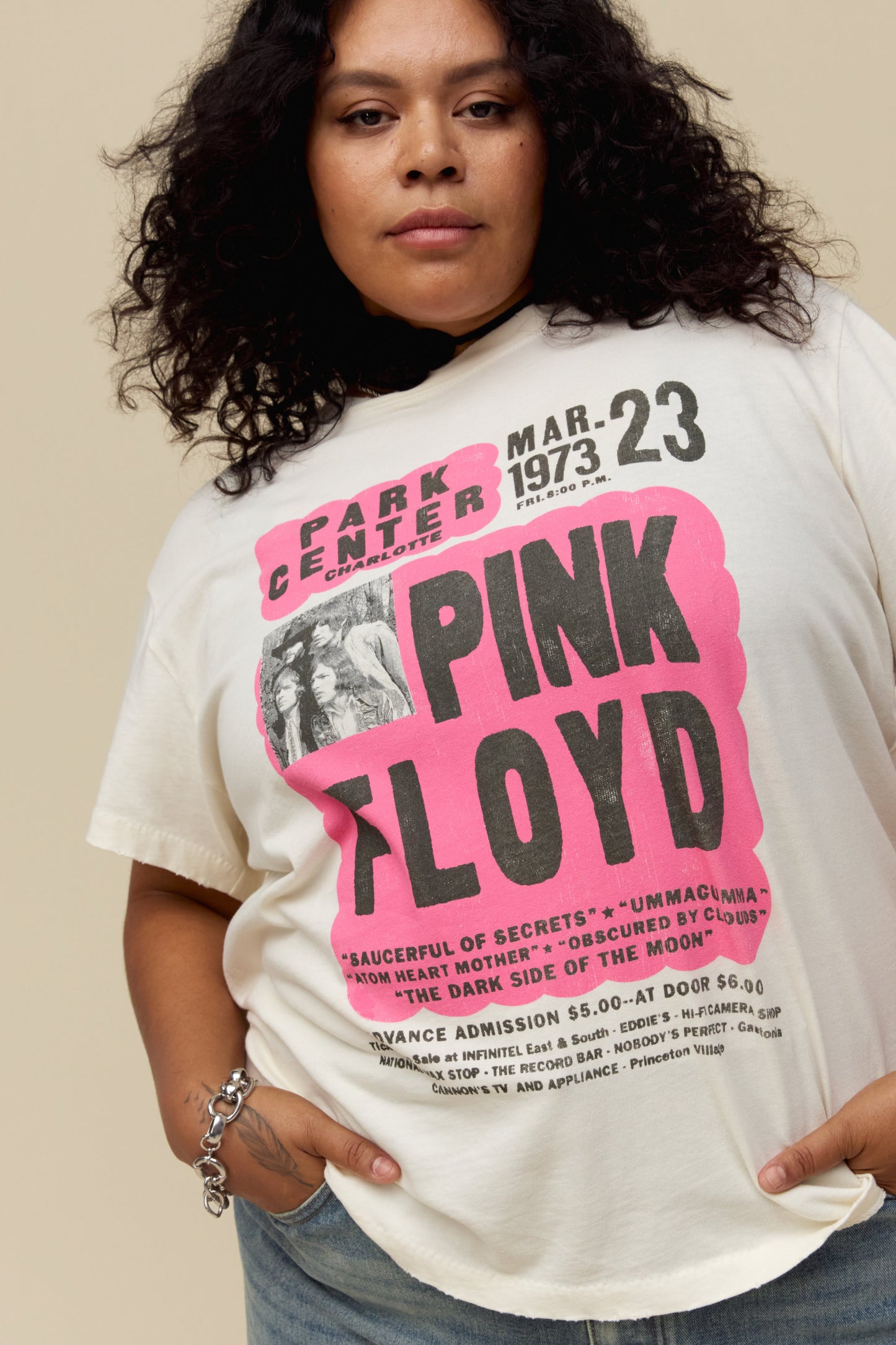 A model featuring a white tee es designed as a true show flyer for Pink Floyd's 1973 Park Center set.
