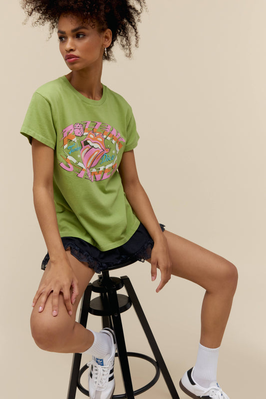 A model featuring a matcha colored tour tee stamped with Rolling Stones and their iconic logo.