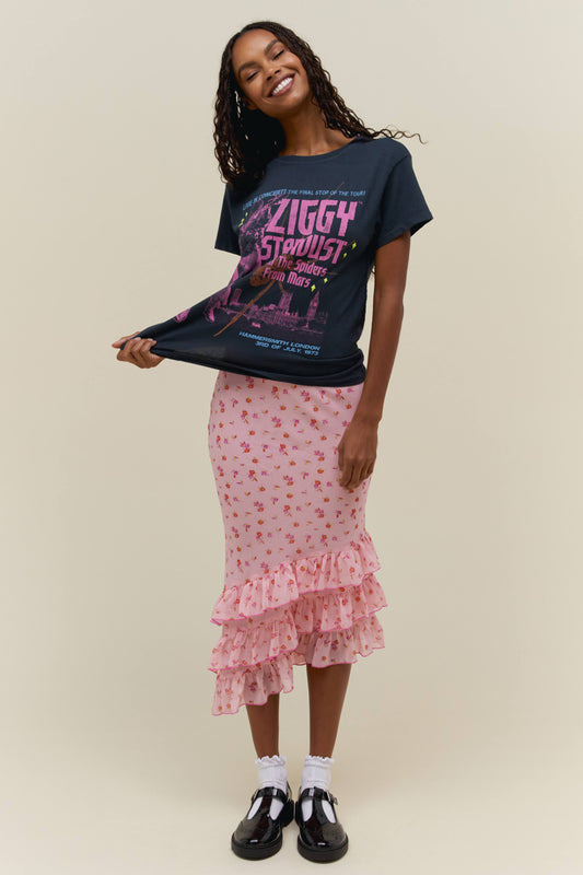 A dark-haired model wearing a black tee featuring a large font ZIGGY STARDUST AND THE SPIDERS FROM MARS and a graphic design of the artist