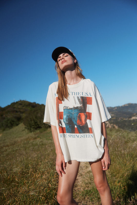 Model wearing an oversized Bruce Springsteen Born In The USA graphic tee in stone vintage.