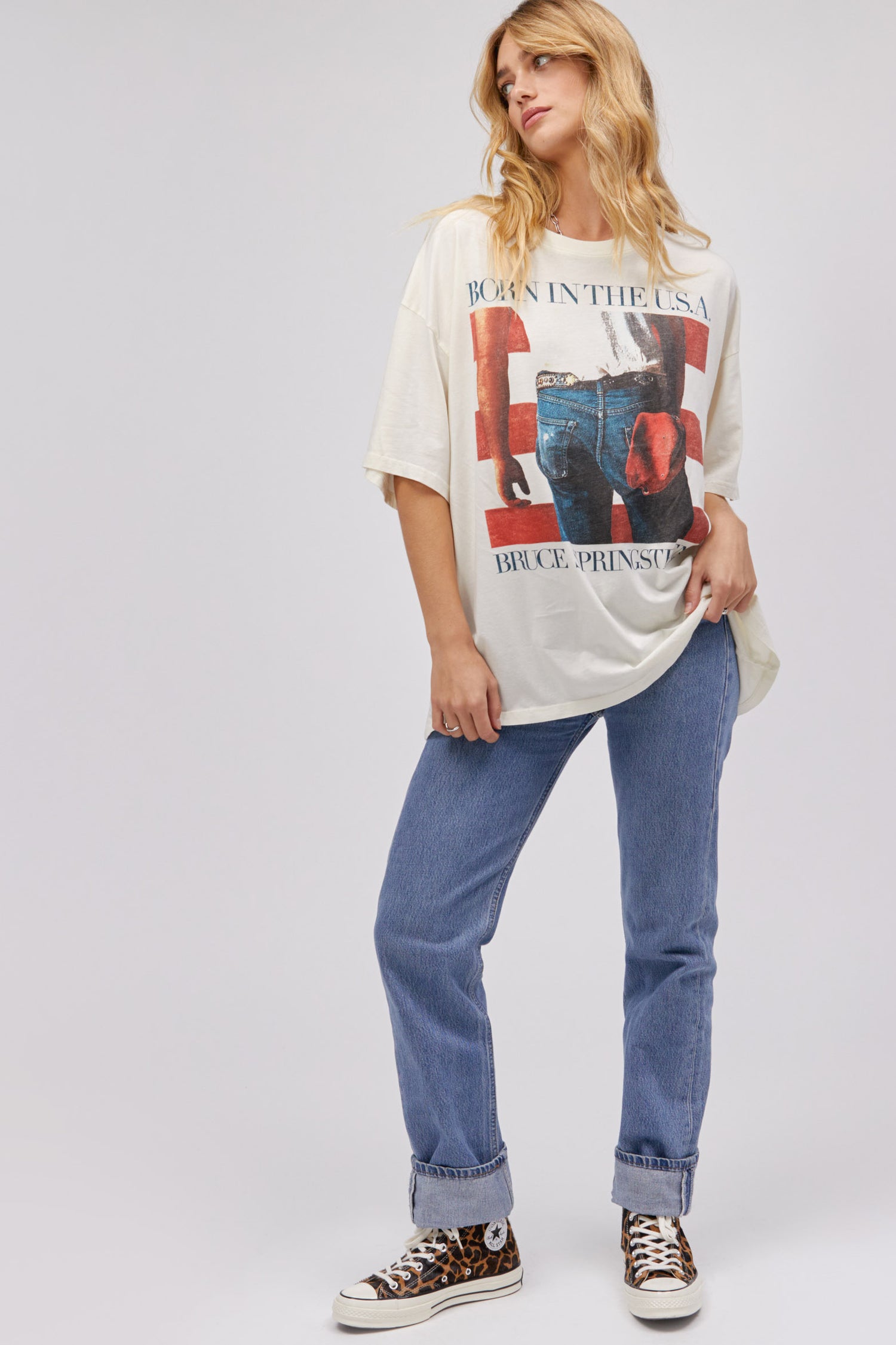 Model wearing an oversized Bruce Springsteen Born In The USA graphic tee in stone vintage.