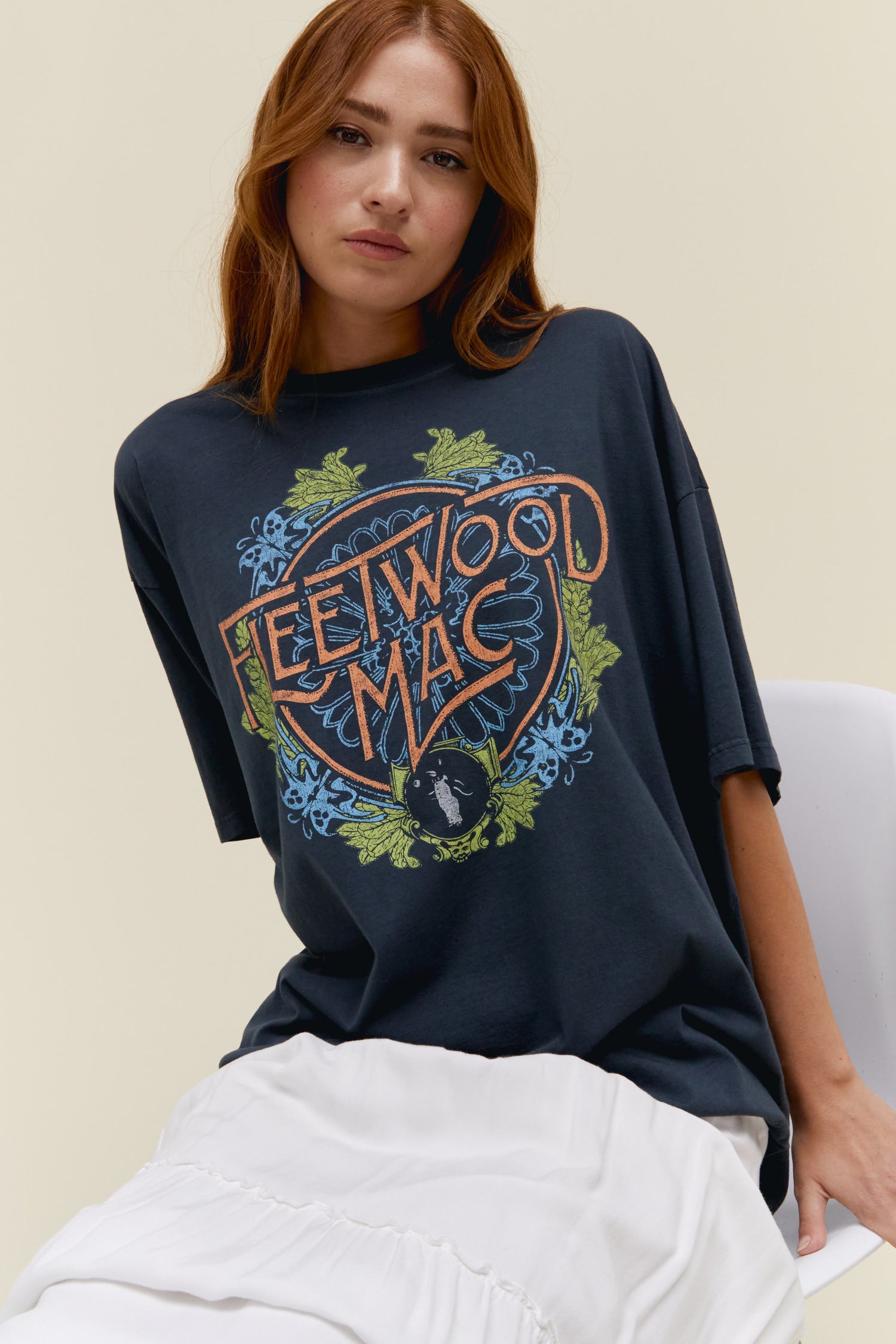 Model wearing an oversized Fleetwood Mac flower crest graphic tee in vintage black.