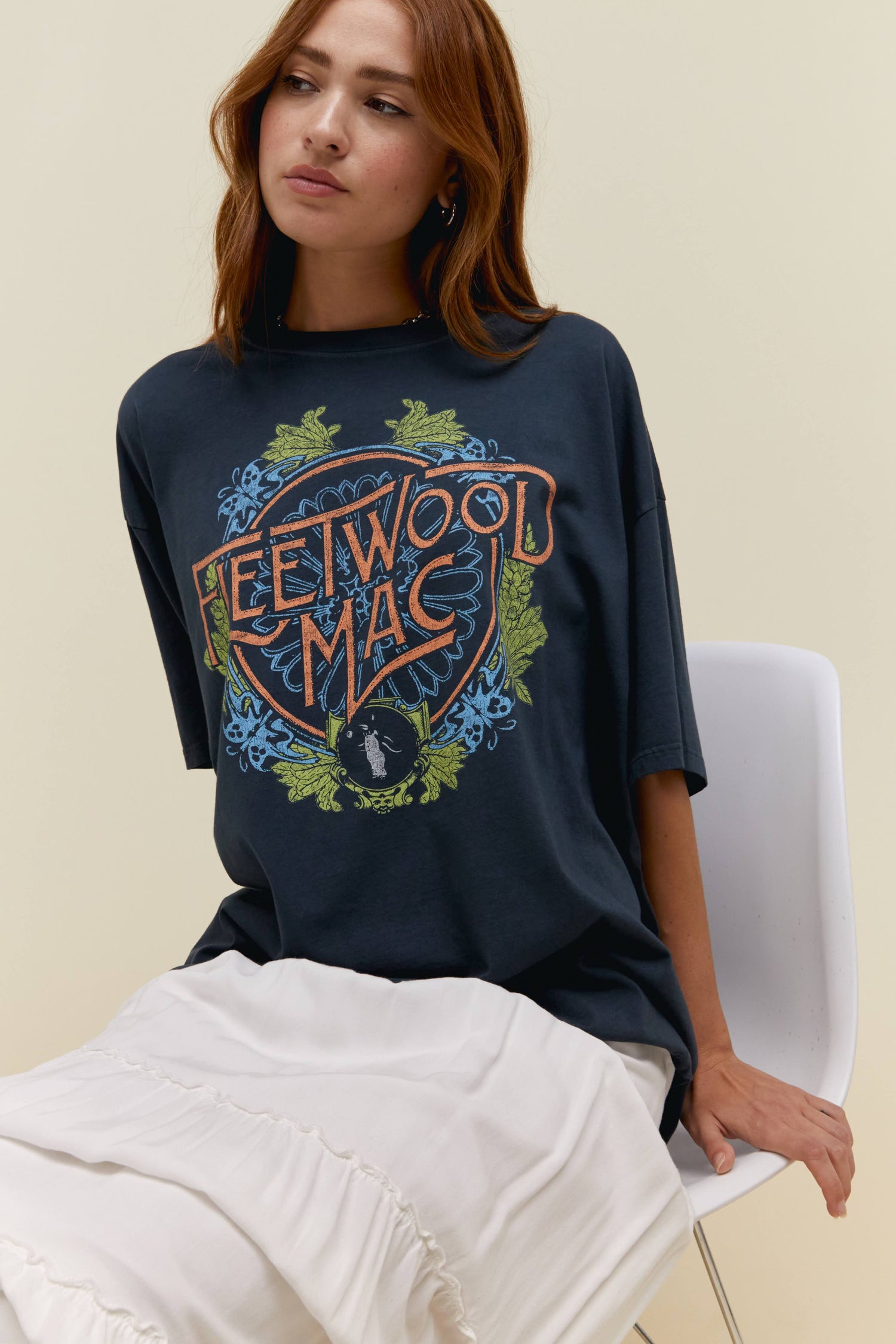 Model wearing an oversized Fleetwood Mac flower crest graphic tee in vintage black.