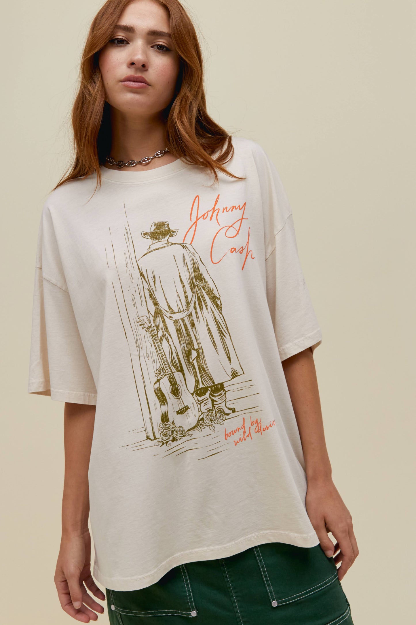 Model wearing an oversized Johnny Cash graphic tee in off white with puff ink autograph detailing.