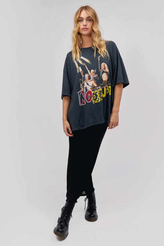 A blonde-haired model featuring a black tee designed with a group photo of the band and stamped with the bands name "No Doubt".