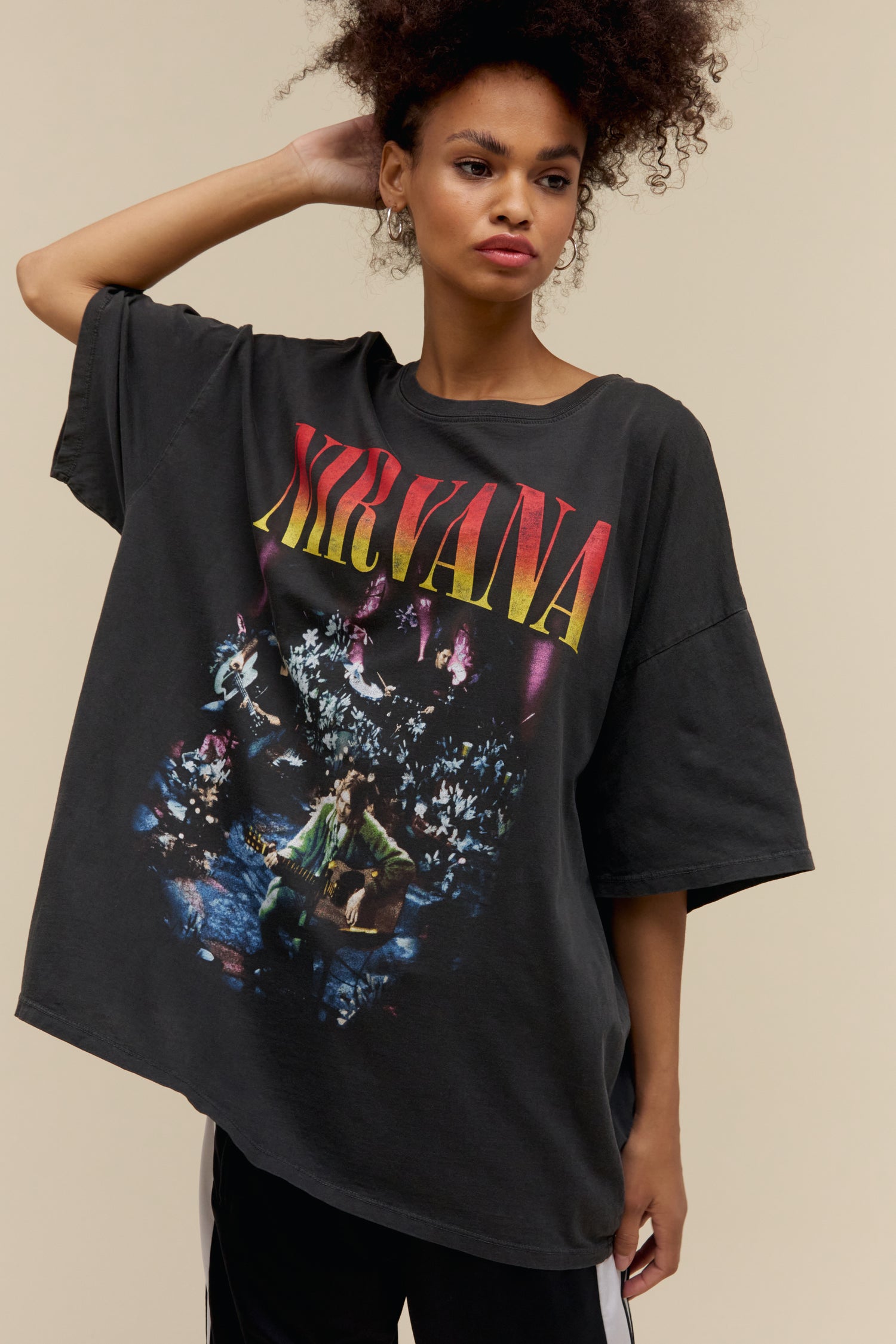 Model wearing a Nirvana MTV Unplugged graphic tee in pigment dyed black with an exaggerated oversized fit