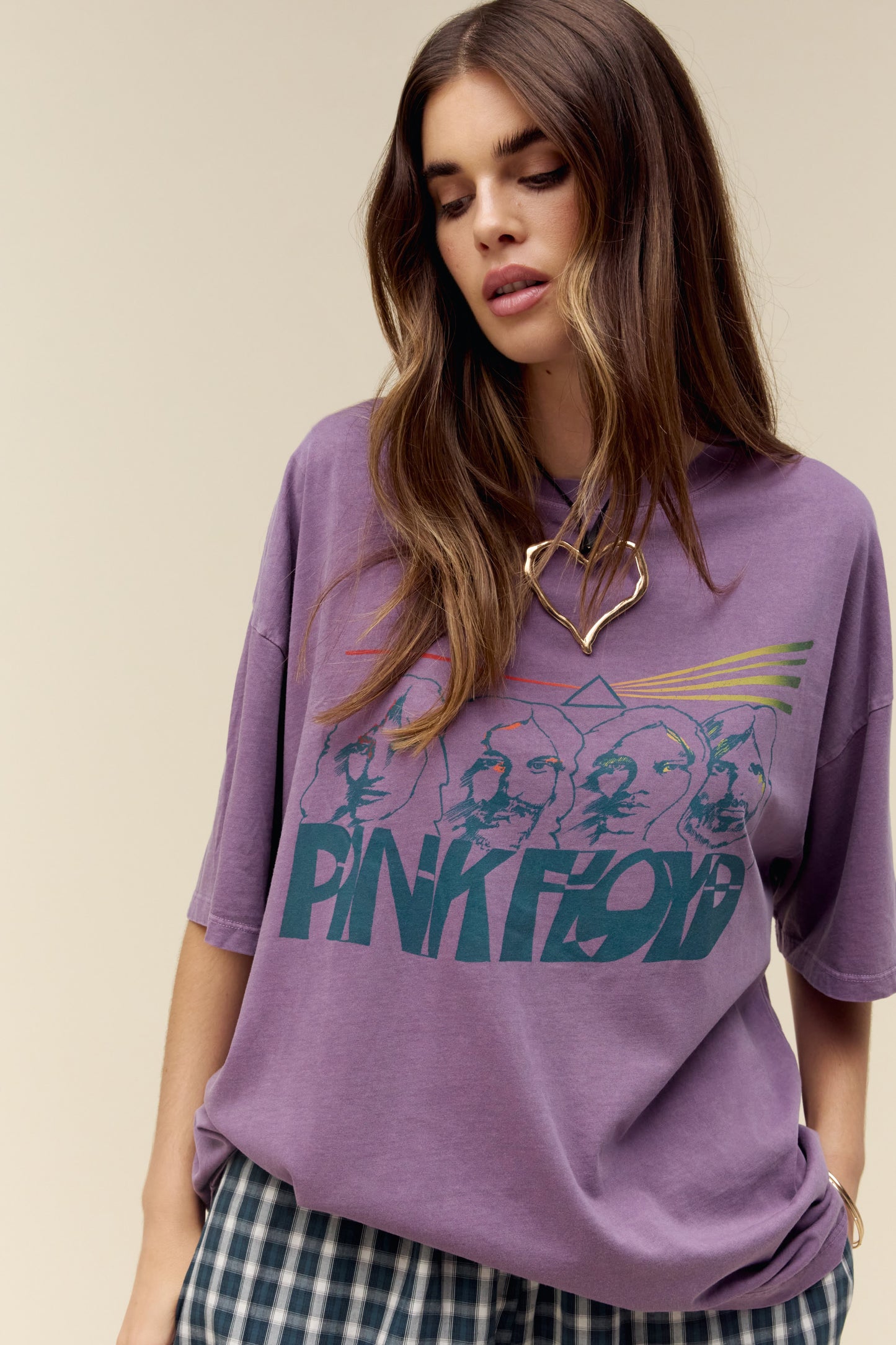 A model featuring a purple colored OS tee accented with "Pink Floyd" in warped font and their enduring light prism symbol.