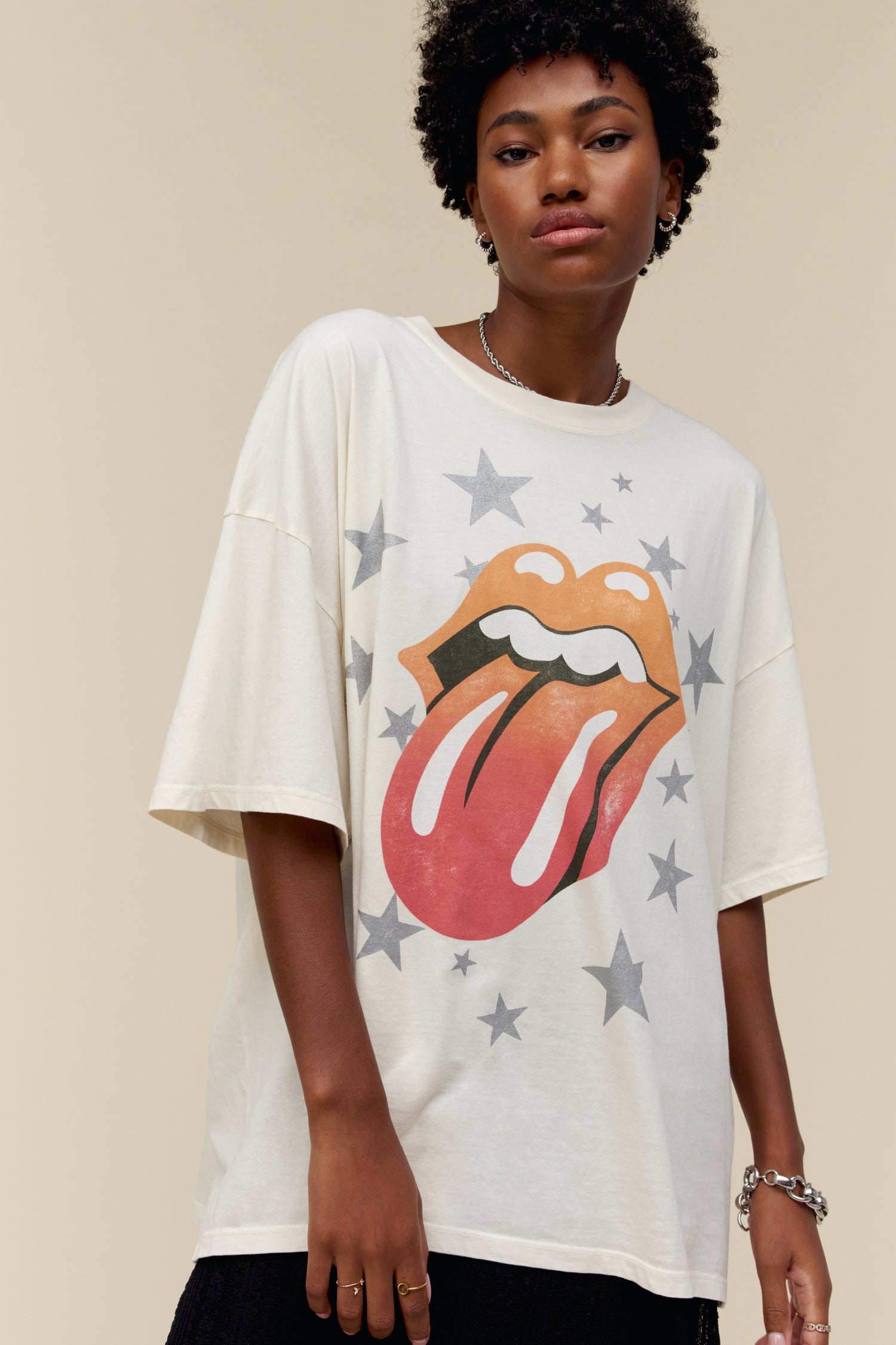 Model wearing an oversized Rolling Stones graphic tee in dirty white