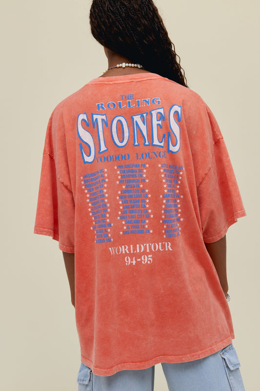 A model featuring an OS Tee stamped with 'World Tour  94-95' with a graphic tongue and tour places at the back