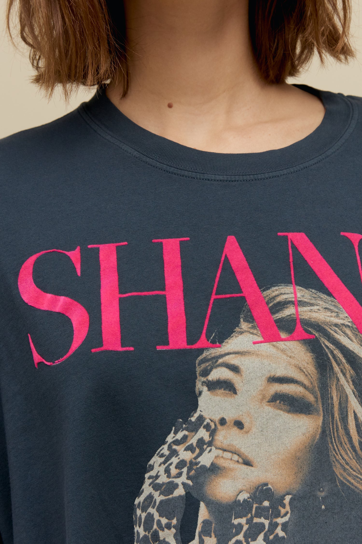 Model wearing an oversized Shania Twain 'Let's Go Girls' graphic tee in vintage black
