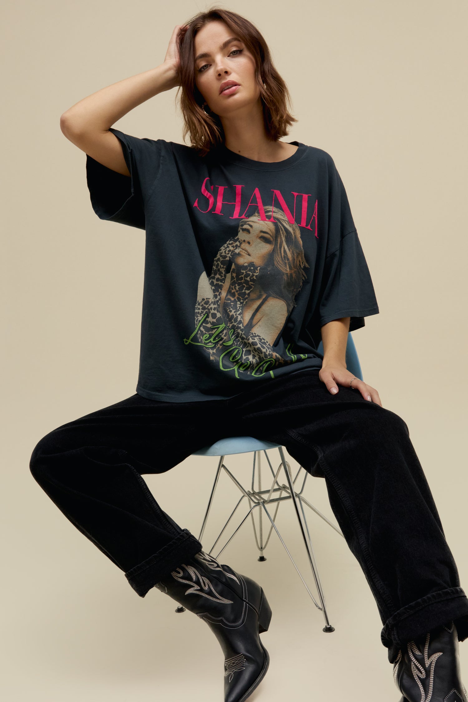 Model wearing an oversized Shania Twain 'Let's Go Girls' graphic tee in vintage black