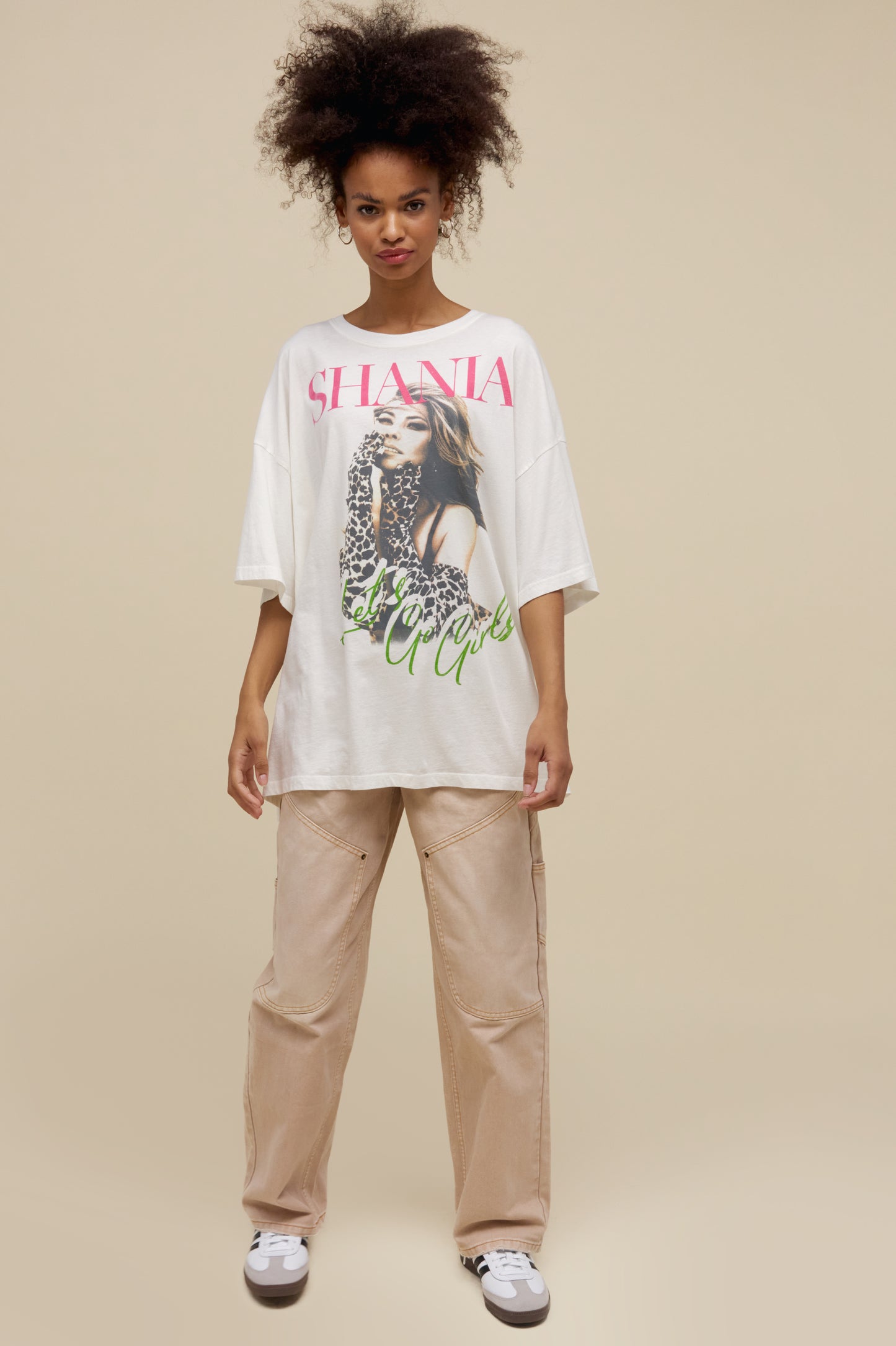 Model wearing an oversized Shania Twain 'Let's Go Girls' graphic tee in vintage white