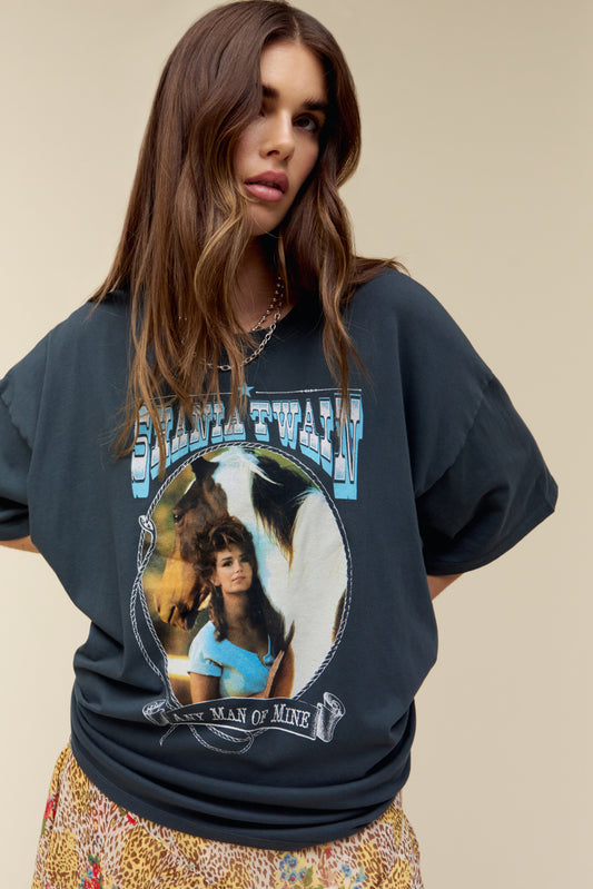 Model wearing an oversized Shania Twain 'Any Man Of Mine' graphic tee in vintage black featuring portrait artwork of the country singer