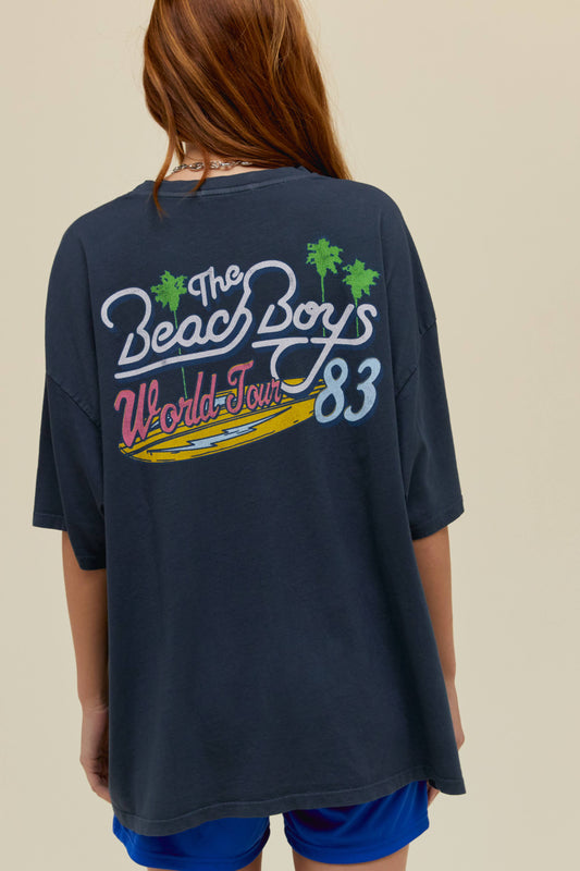 Model wearing an oversized The Beach Boys graphic tour tee in vintage black.