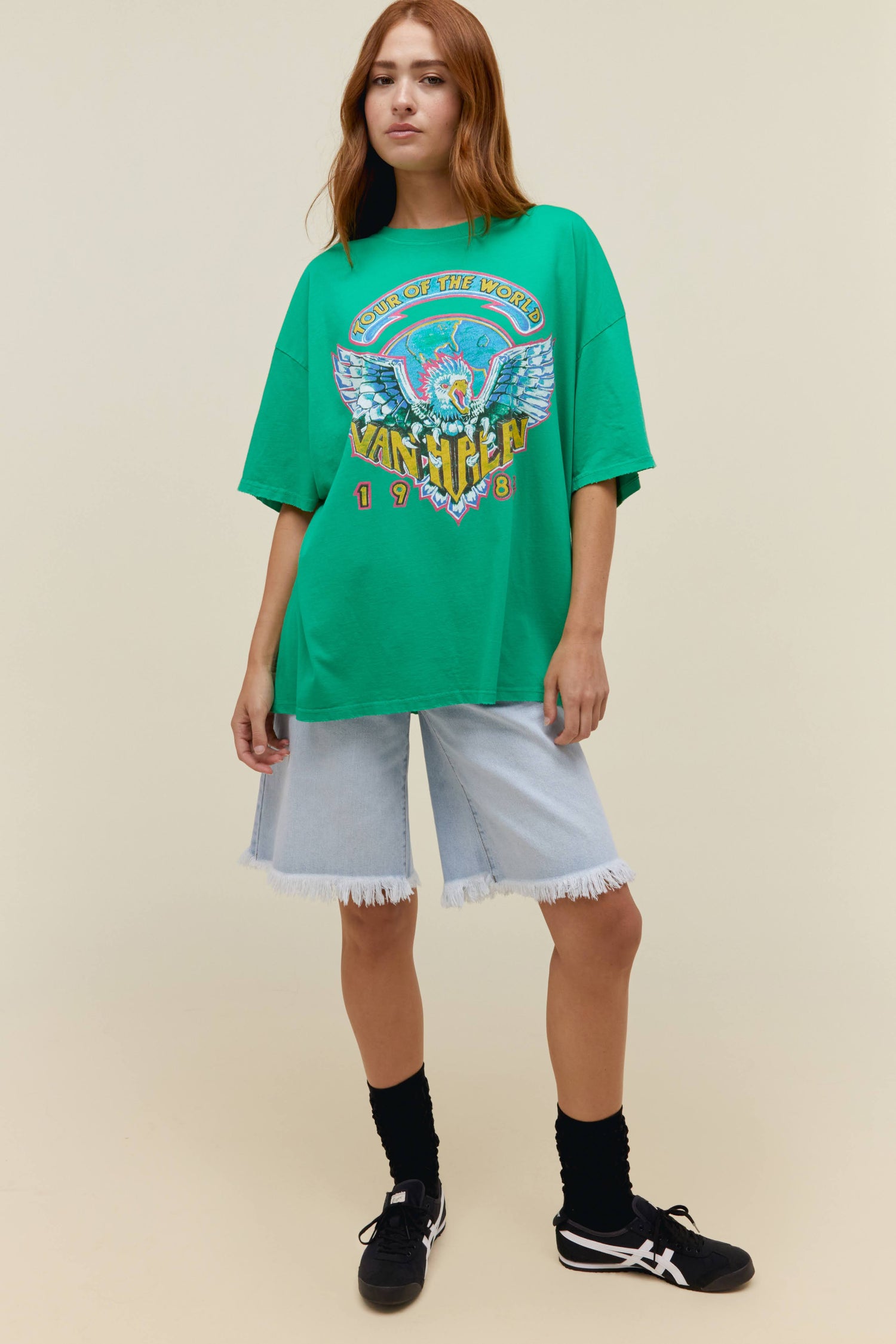  A model featuring a mint green tee with "Tour of the World" across the chest area and a graphic of the Van Halen tour below 