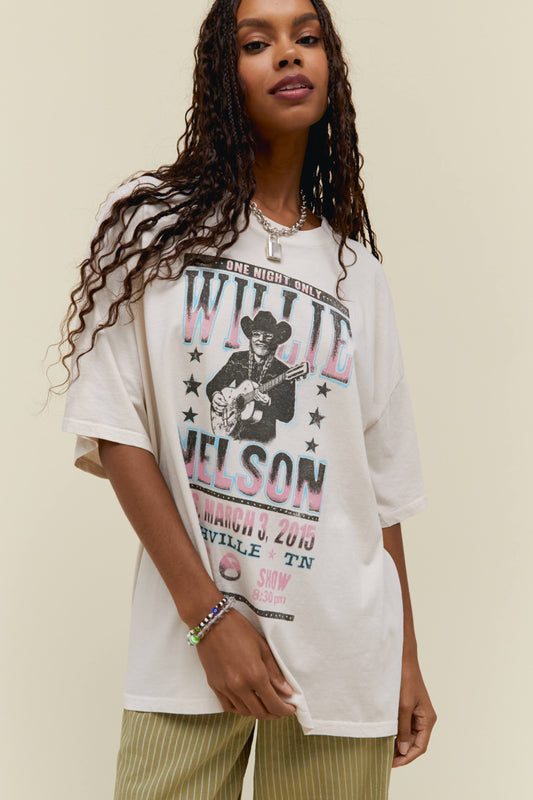 A model featuring a white os tee stamped with 'Willie Nelson' and a graphic of him playing guitar