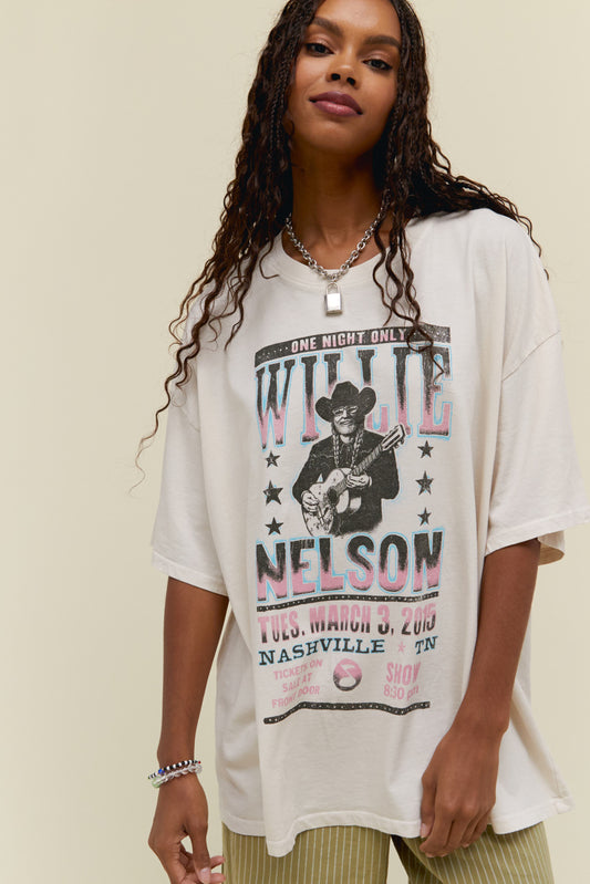 A model featuring a white os tee stamped with 'Willie Nelson' and a graphic of him playing guitar
