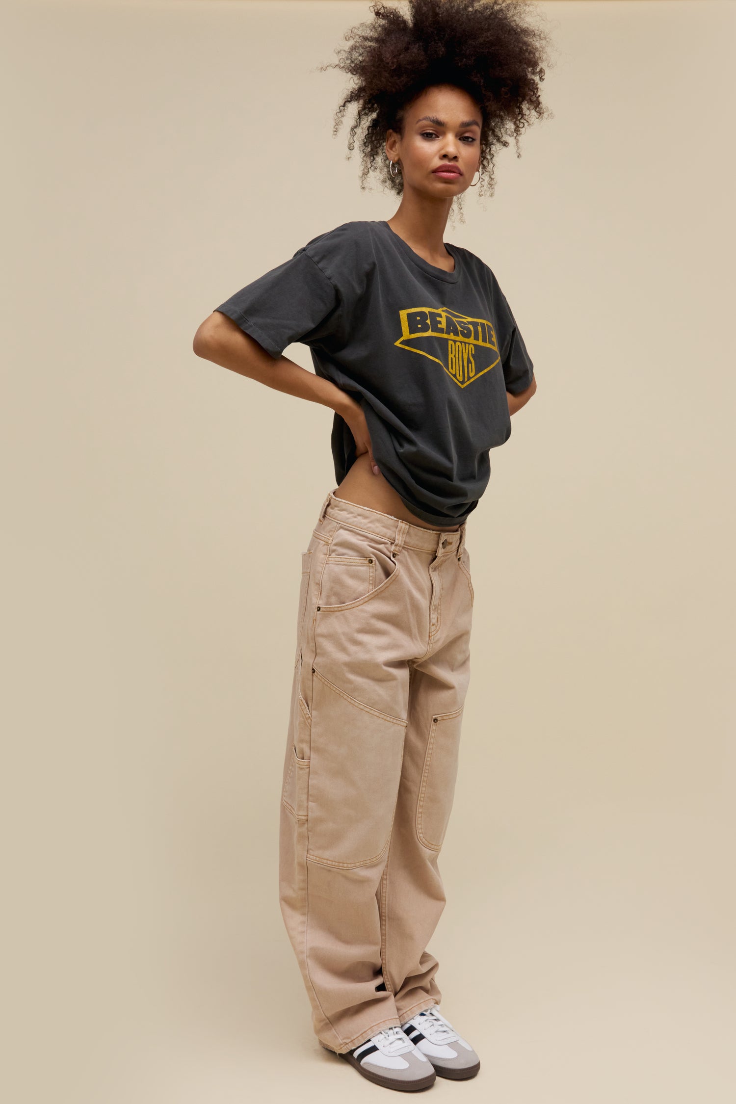 Model wearing a classic Beastie Boys logo graphic tee in pigment dyed black with an oversized fit