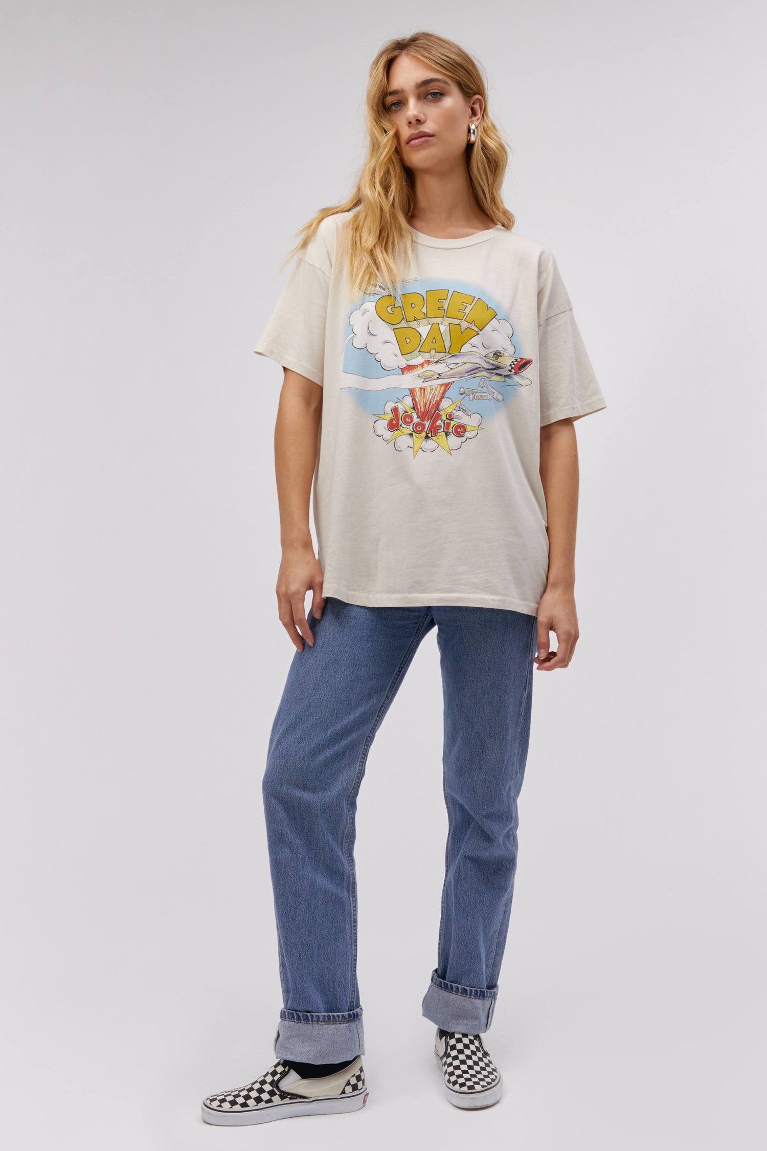 A blonde-haired model featuring a white tee designed with the Green Day's album Dookie cover.