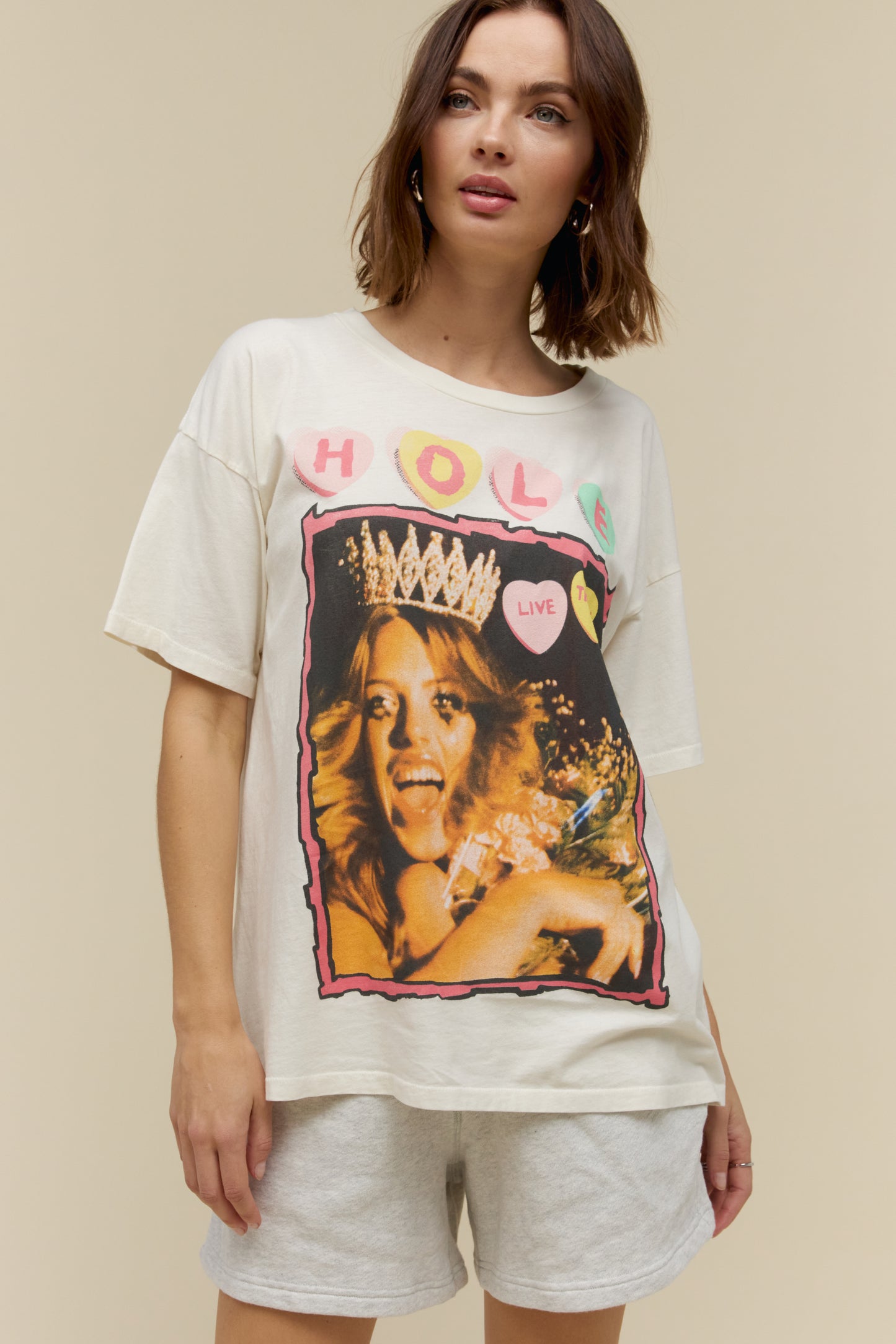 Model wearing a 90s Hole merch tee with grungy, poster style designed with the original artwork from Hole’s second studio album “Live Through This.” The tour details stamped along the back.