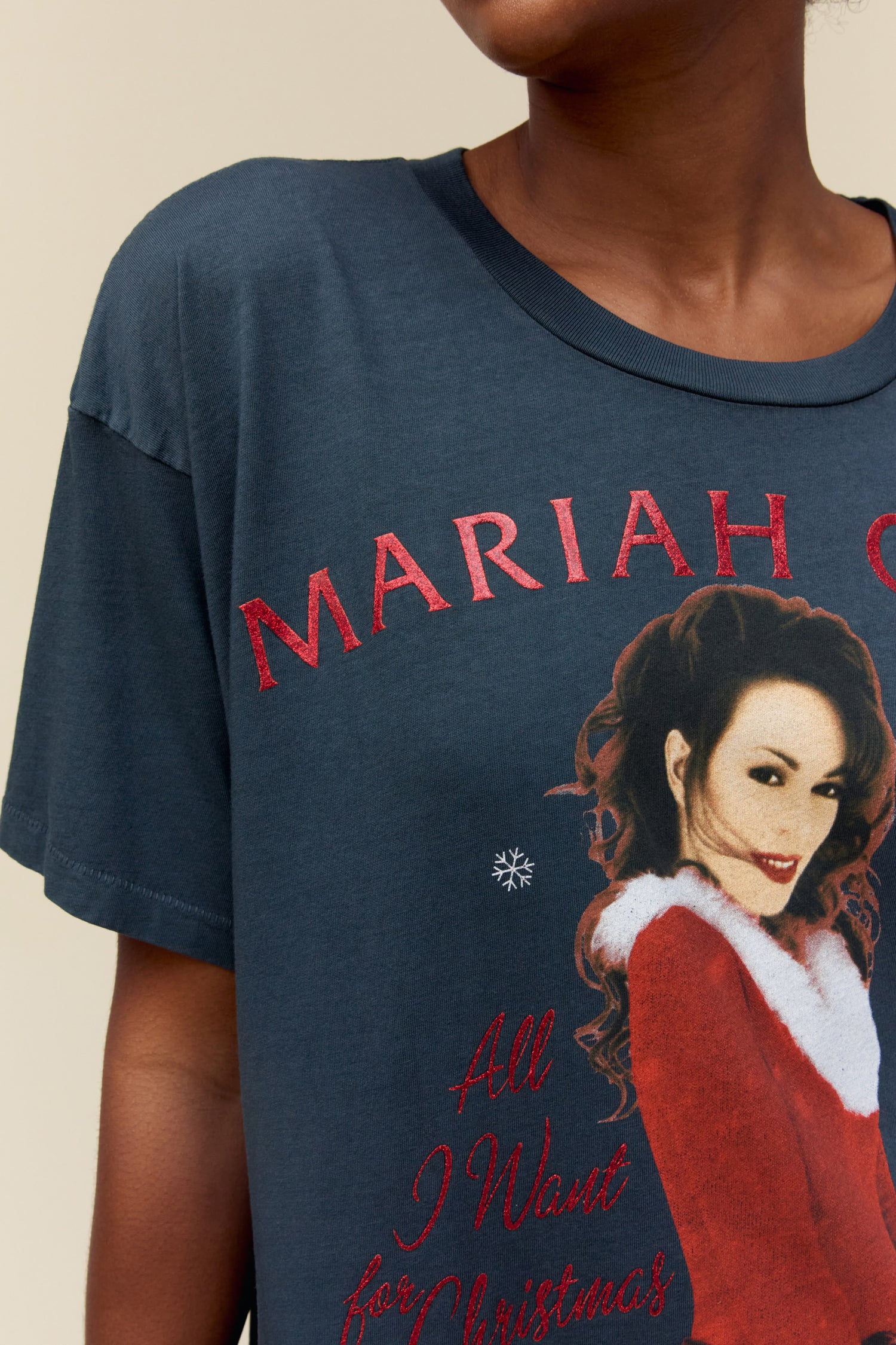 Model wearing a Mariah Carey graphic tee featuring 'All I Want for Christmas is You' portrait artwork