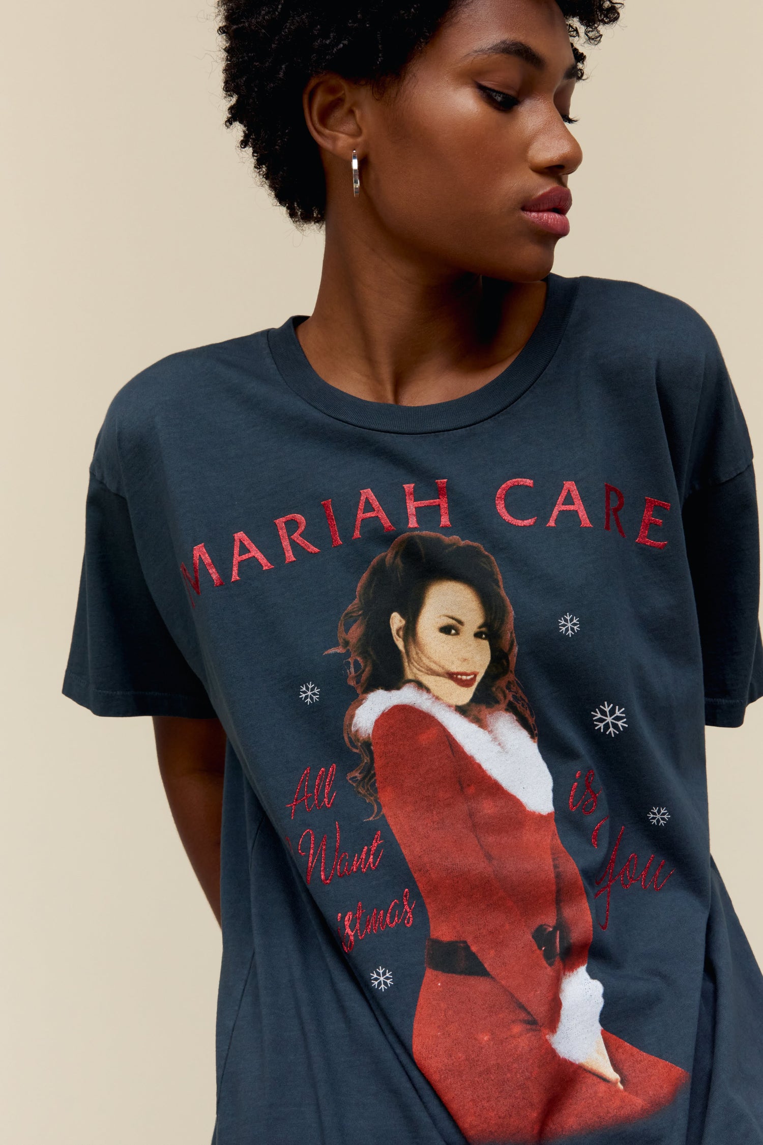 Model wearing a Mariah Carey graphic tee featuring 'All I Want for Christmas is You' portrait artwork