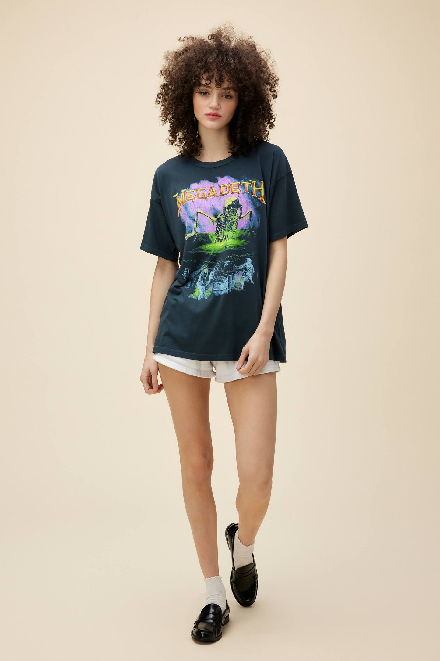 Curly-haired model wears a Megadeth 'Contaminated' graphic tee with front and back artwork.