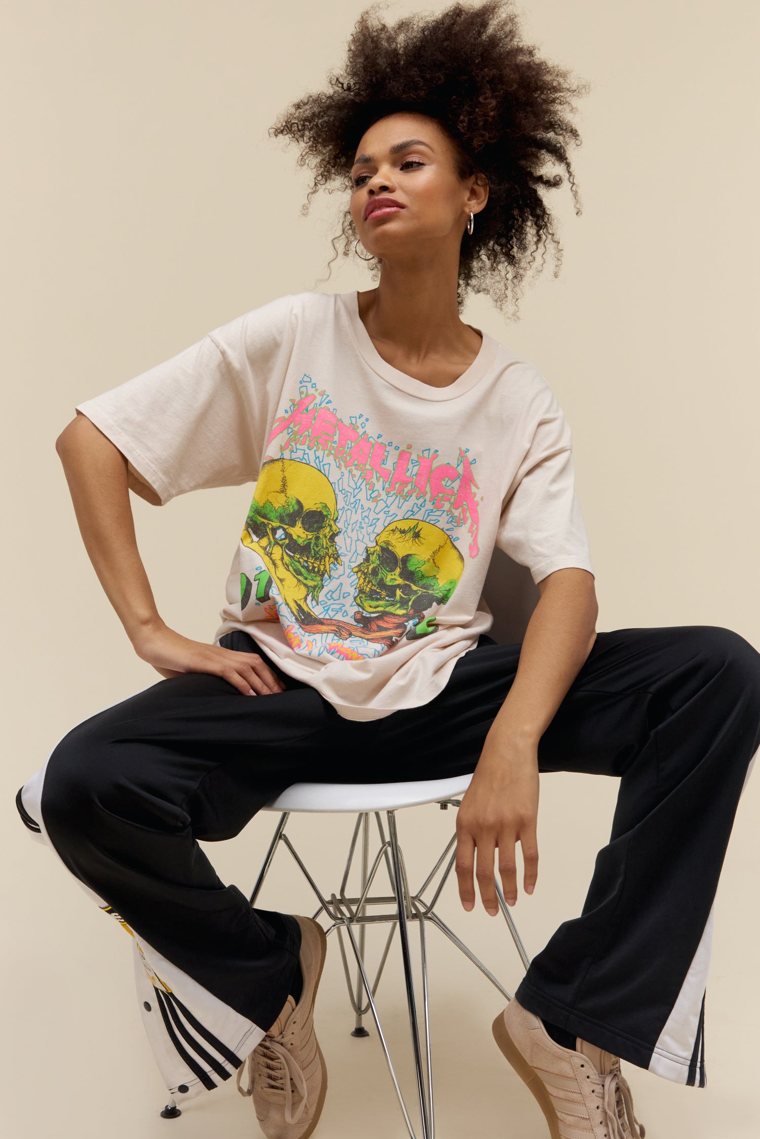Model wearing an oversized Metallica 'Wherever I May Roam' graphic tee in dirty white with skull artwork