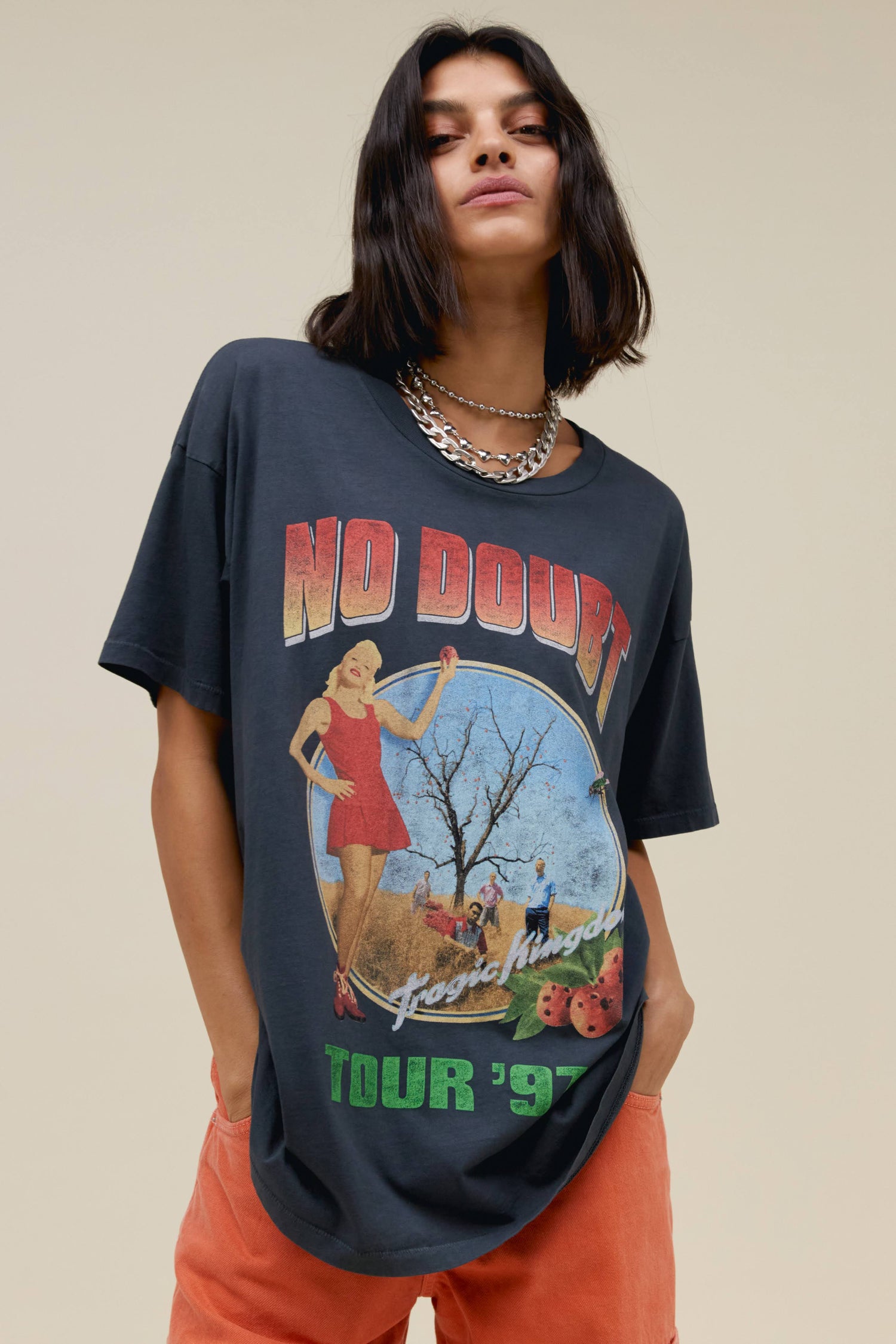 Model with bob wearing No Doubt black graphic tee and orange pants.