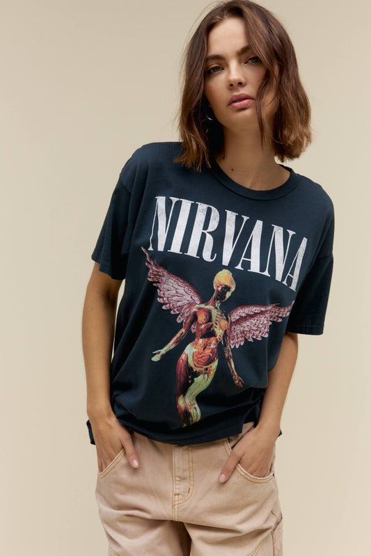 A model featuring a black colored merch tee stamped with Nirvana's Utero album cover.