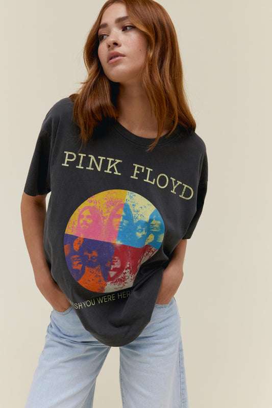 A model featuring a black tee stamped with "Pink Floyd" and a collage picture of the band.