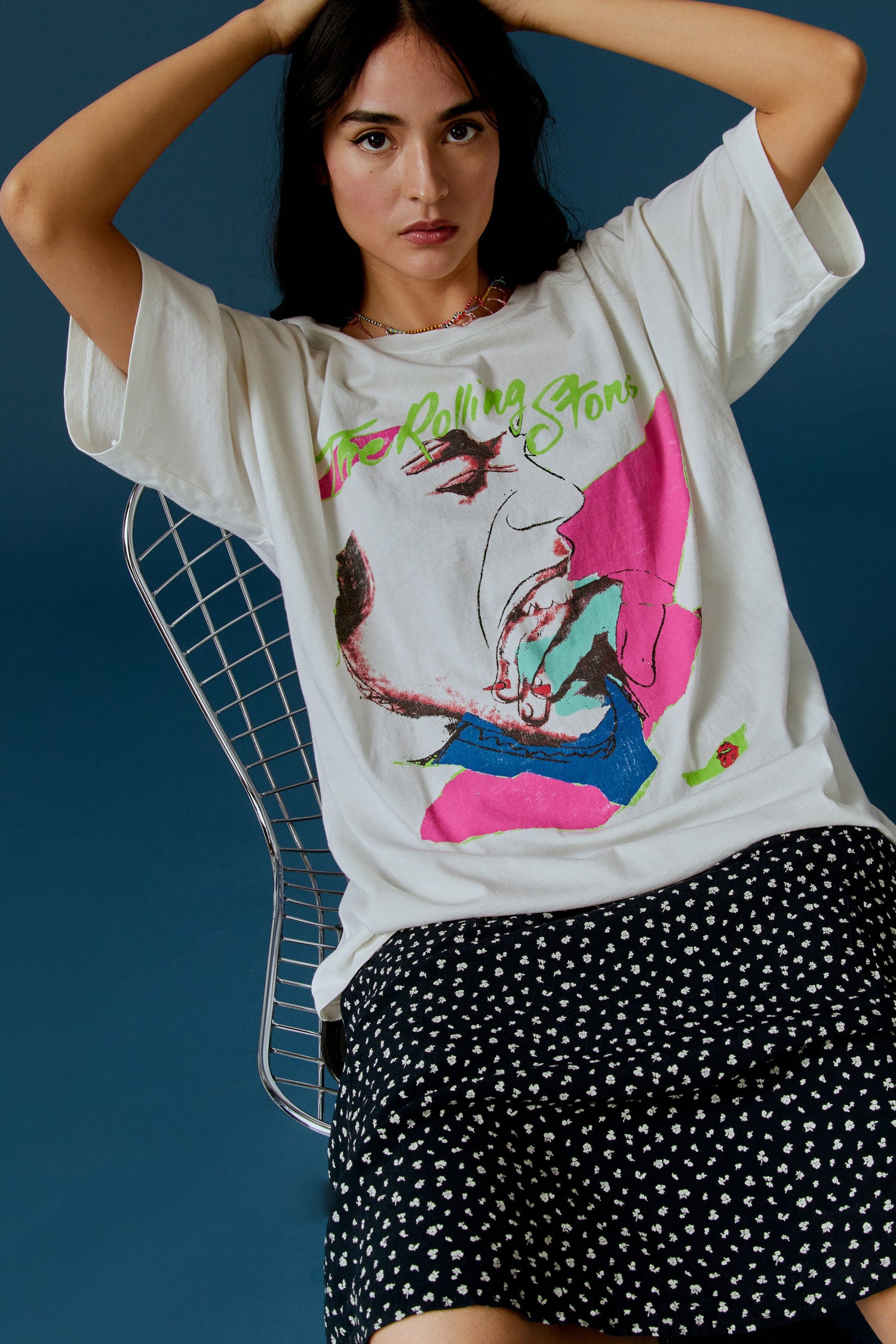 A dark-haired model featuring a white tee designed with the Rolling Stones album cover, Love You Live.
