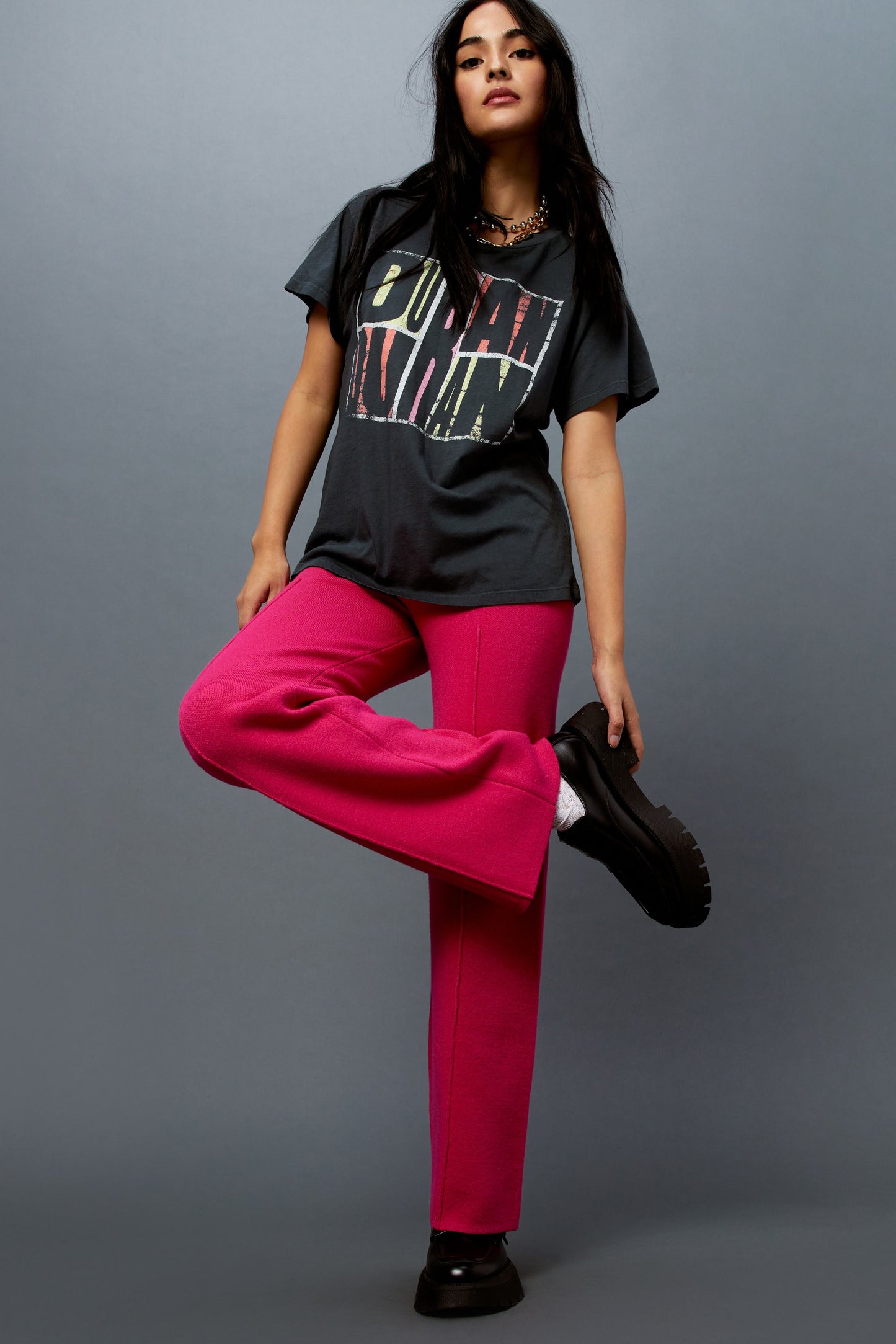 Model wearing a Duran Duran graphic tee styled with knit pintuck pants in pink rose