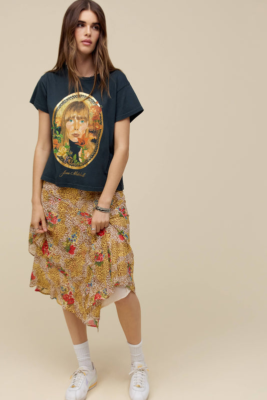 A model featuring a vintage black Joni Mitchell solo tee designed with an icon of the artist herself accented in gold foil.