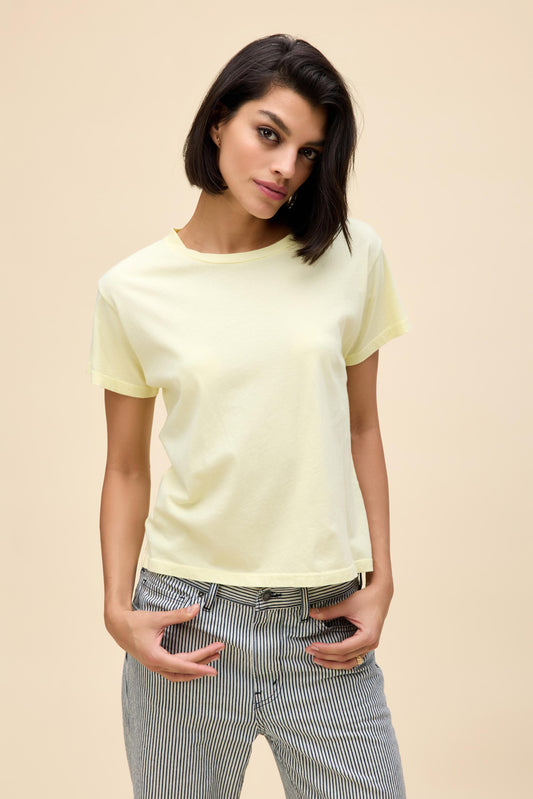 Model wearing a slightly fitted t-shirt in solid light yellow