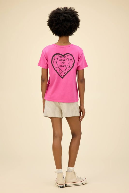 Curly-haired model wearing a Blondie graphic ringer tee in pink with 'Heart Of Glass' artwork on the front and back.