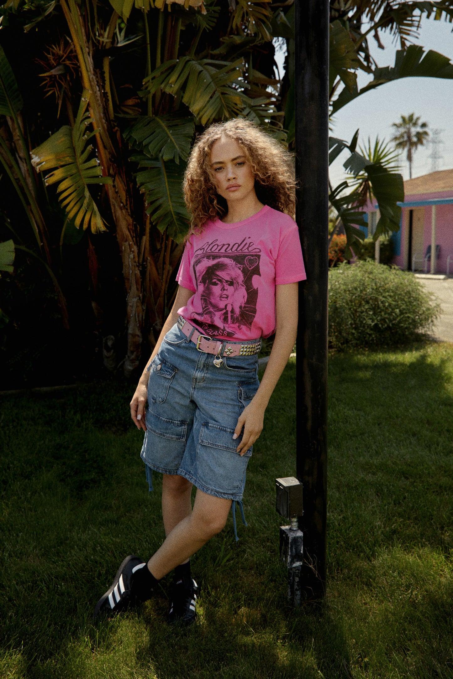 Model wearing Blondie graphic tee in pink with "Heart Of Glass" artwork on front.