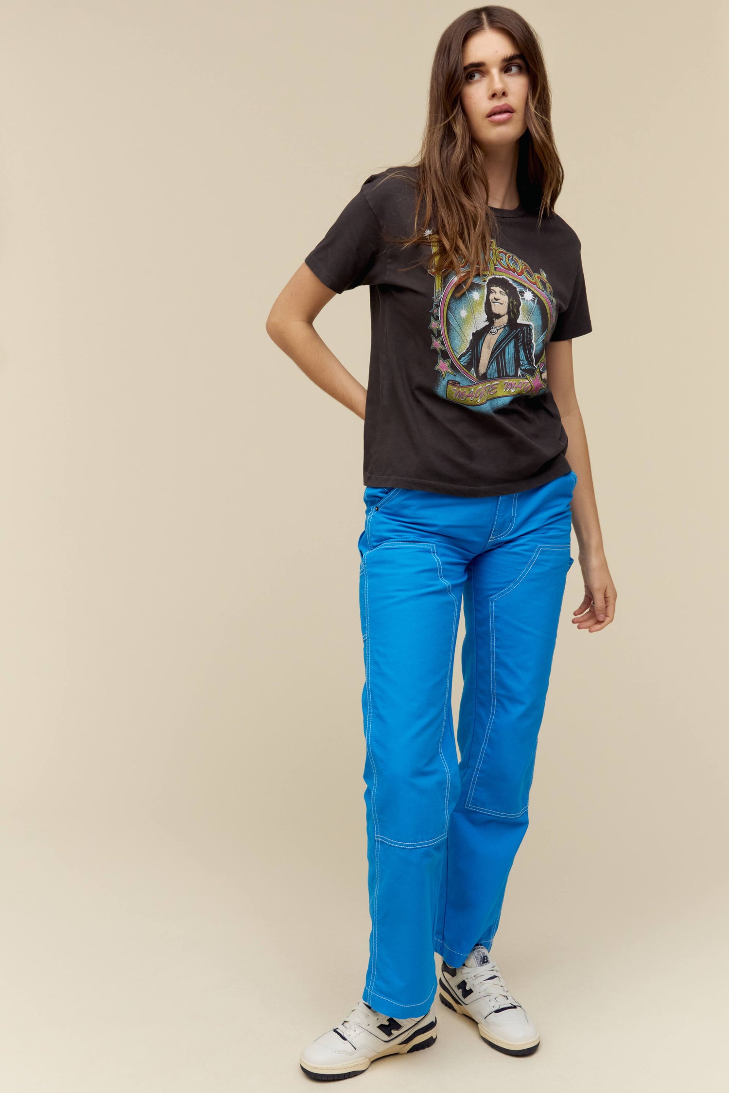A model featuring a washed black tee stamped with Rod Stewart and a hand-drawn graphic of him center chest.
