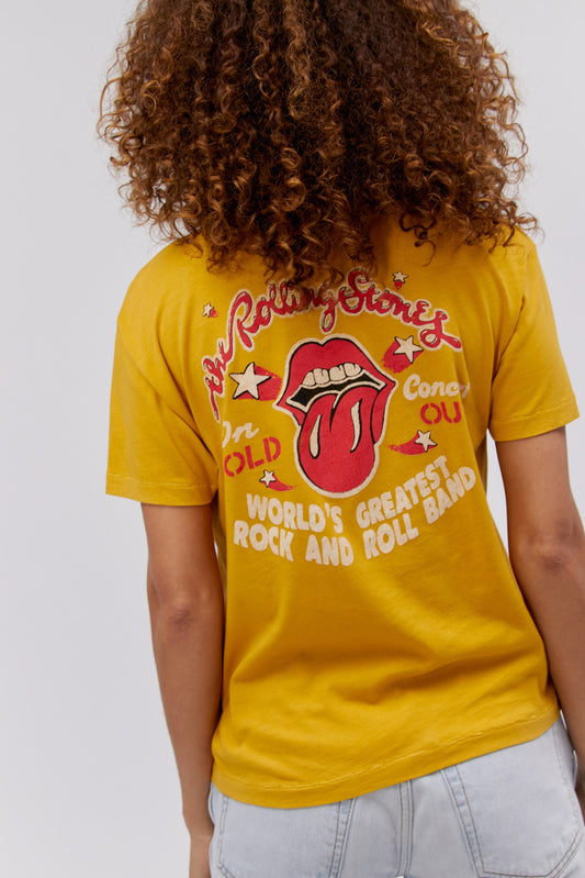 A curly-haired model featuring a golden daze tee stamped with 'The Rolling Stones' and designed with an iconic group photo of the band.