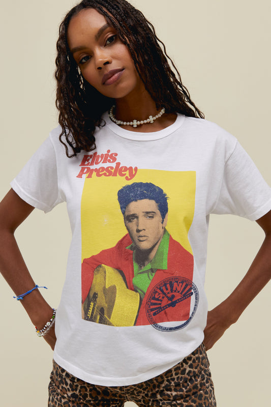 A model featuring a white tee stamped with "Elvis presley" and designed with a portrait of the artist itself.
