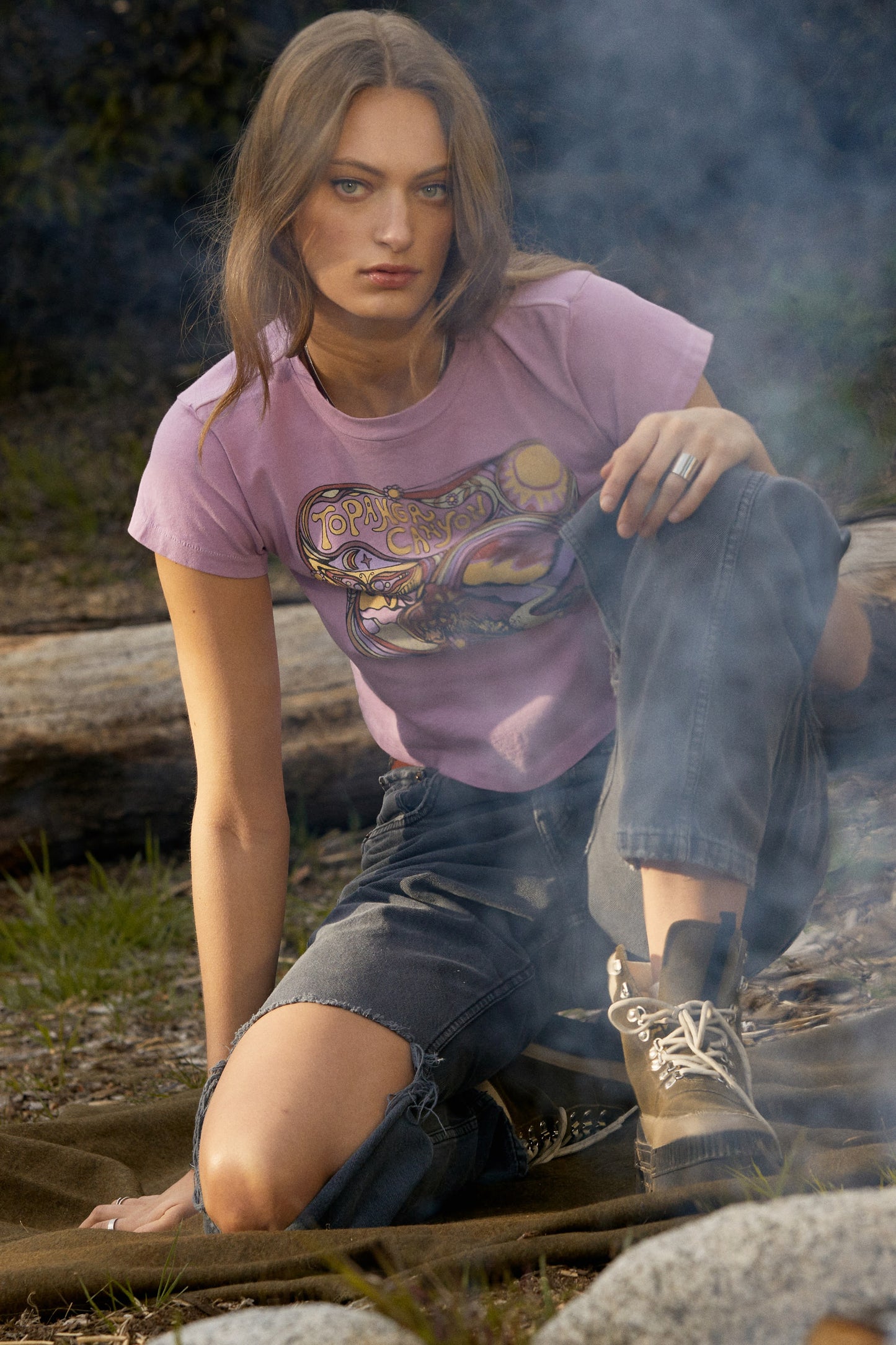 model sitting by fire