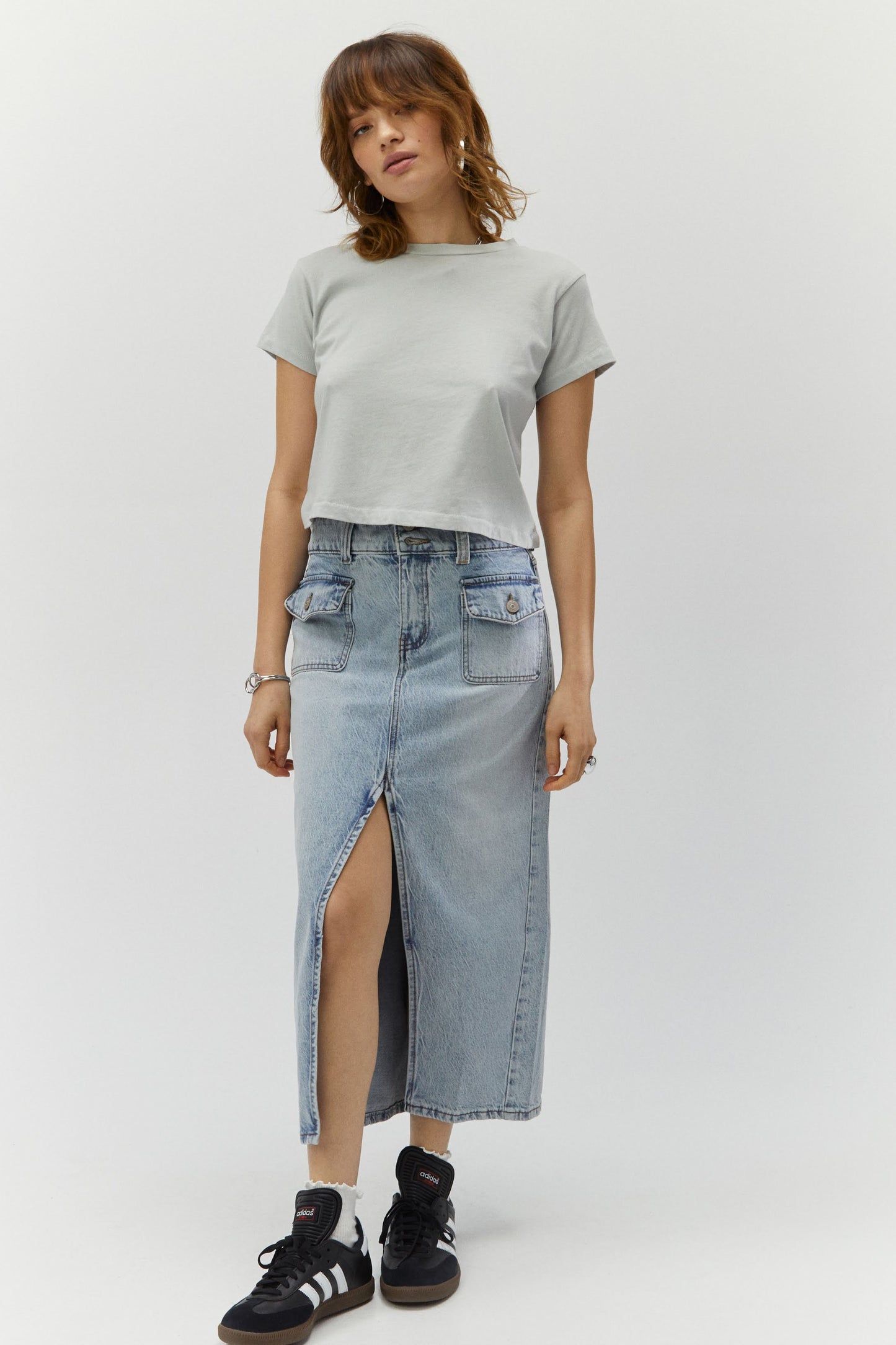 Model wearing a grey crop tee paired with a denim cargo midi skirt.