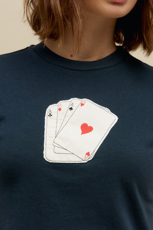 A model featuring a black vintage tee designed with a graphic of cards in the middle.