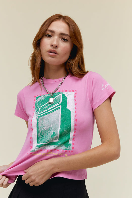 A model featuring a pink vintage tee with a distressed amp graphic.