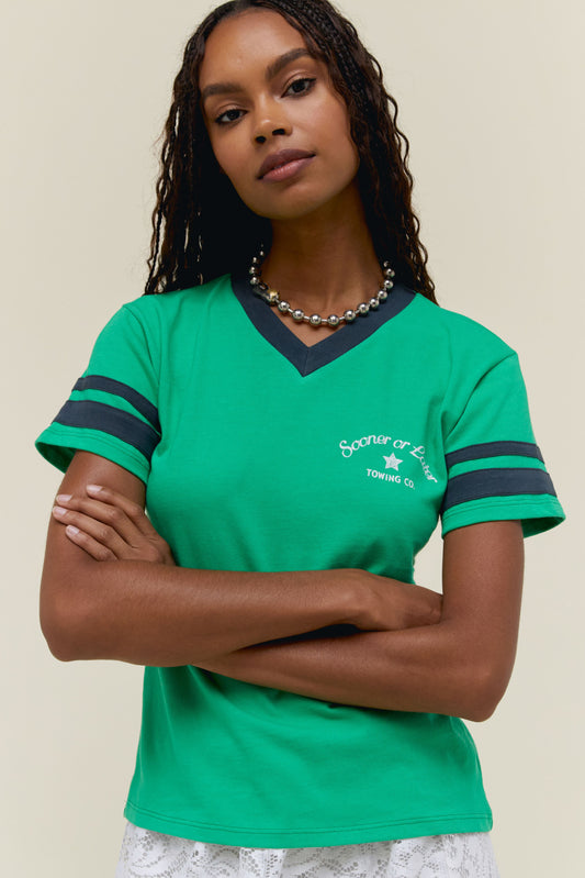 A model featuring a geen vneck sporty tee with stripes on each sleeves and stamped with 'Sooner or Later'